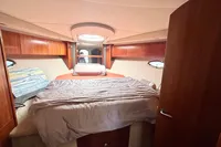 2007 Cruisers Yachts 447 Sport Sedan cabin with bed, wood paneling, and portholes.