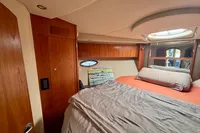 2007 Cruisers Yachts 447 Sport Sedan bedroom with wood cabinetry and skylight.