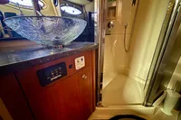 Luxurious bathroom in 2007 Cruisers Yachts 447 Sport Sedan with glass sink and shower.