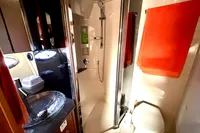 2007 Cruisers Yachts 447 Sport Sedan bathroom with shower, sink, and orange towel.