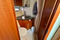 2007 Cruisers Yachts 447 Sport Sedan bathroom with wood cabinetry and modern fixtures.