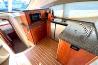 2007 Cruisers Yachts 447 Sport Sedan kitchen with wood cabinetry and modern appliances.