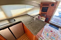 Luxurious 2007 Cruisers Yachts 447 Sport Sedan interior with modern kitchen and cozy seating area.