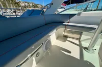 2007 Cruisers Yachts 447 Sport Sedan interior with blue seating and marina view.
