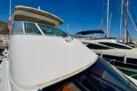 2007 Cruisers Yachts 447 Sport Sedan docked at marina under clear blue sky.