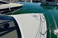2007 Cruisers Yachts 447 Sport Sedan docked in a marina, surrounded by other boats.