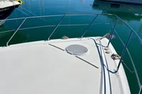 2007 Cruisers Yachts 447 Sport Sedan bow with railing, docked on calm water.