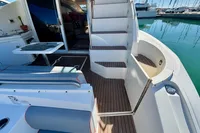2007 Cruisers Yachts 447 Sport Sedan, featuring elegant deck and seating area by the marina.