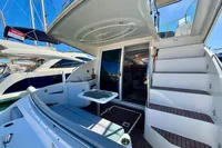 2007 Cruisers Yachts 447 Sport Sedan, spacious deck with seating and stairs, docked in marina.