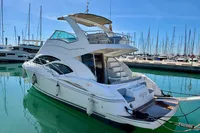 2007 Cruisers Yachts 447 Sport Sedan docked in a marina under clear blue skies.