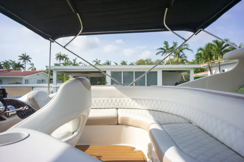  Yacht Photos Pics 2007 Meridian 459 Motoryacht interior with white seating and canopy, surrounded by palm trees.