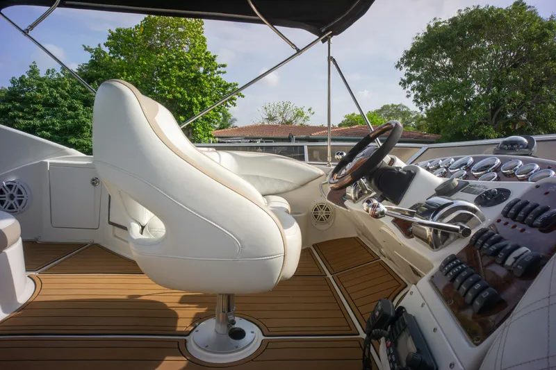  Yacht Photos Pics Luxurious 2007 Meridian 459 Motoryacht helm with white leather seat and modern controls.