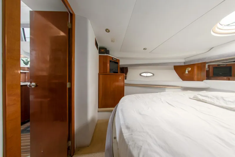  Yacht Photos Pics Luxurious bedroom interior of 2007 Meridian 459 Motoryacht with wood accents and cozy bedding.