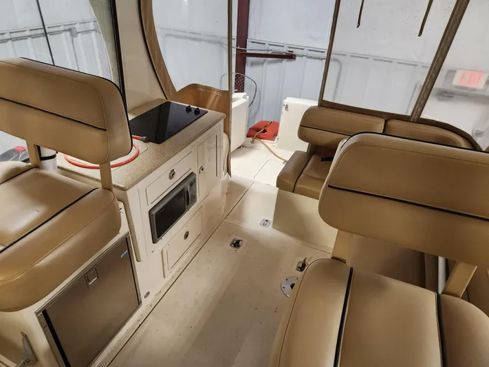  Yacht Photos Pics Interior of 2010 Mainship Pilot 31 boat with beige seating and compact kitchen area.