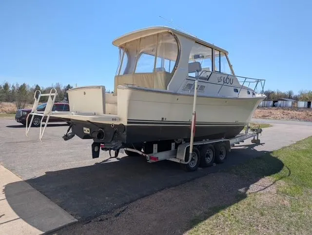  Yacht Photos Pics 2010 Mainship Pilot 31 boat on a trailer, parked outdoors on a sunny day.