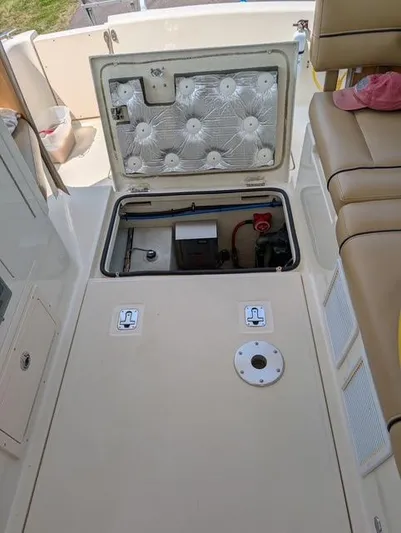  Yacht Photos Pics 2010 Mainship Pilot 31 engine compartment with open hatch, showcasing interior components and seating area.