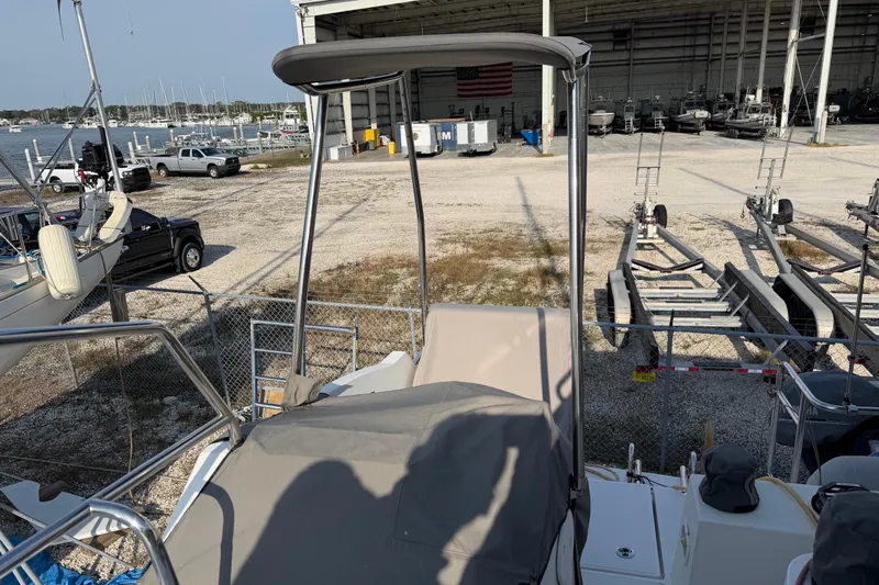 Muse Yacht Photos Pics 2019 Nautitech 40 Open catamaran docked near boatyard with trailers and vehicles.