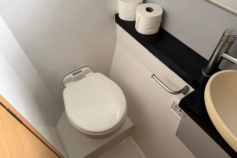 Muse Yacht Photos Pics Compact bathroom in 2019 Nautitech 40 Open yacht with toilet, sink, and toilet paper rolls.