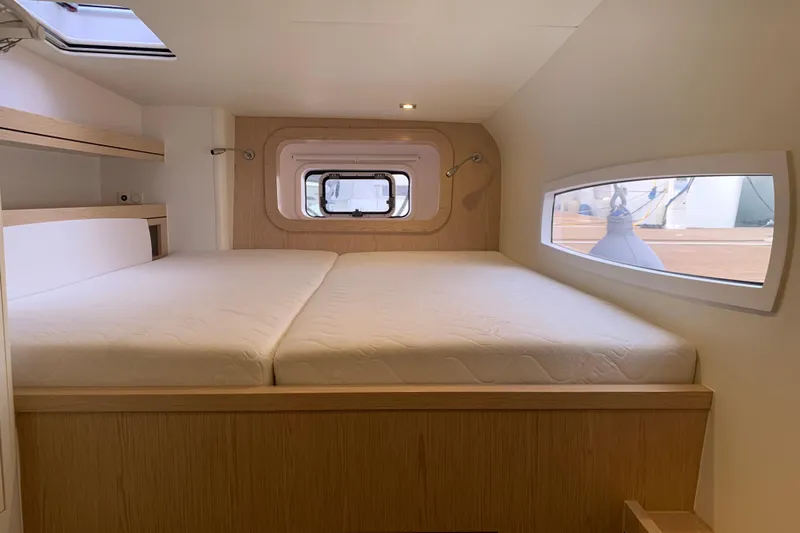 Spekeend Yacht Photos Pics Luxurious cabin interior of 2021 Outremer 51 catamaran with large bed and windows.