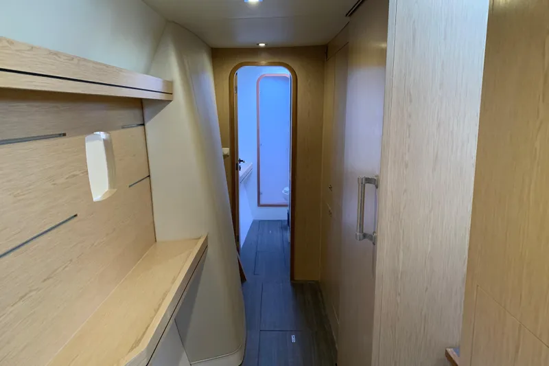 Spekeend Yacht Photos Pics Interior hallway of 2021 Outremer 51 yacht, featuring modern wood paneling and sleek design.