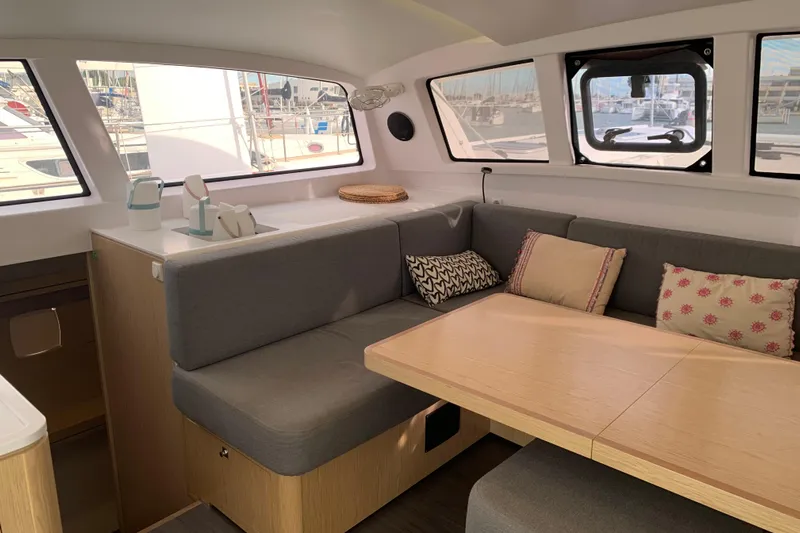 Spekeend Yacht Photos Pics Interior of 2021 Outremer 51 yacht with cozy seating and dining area.