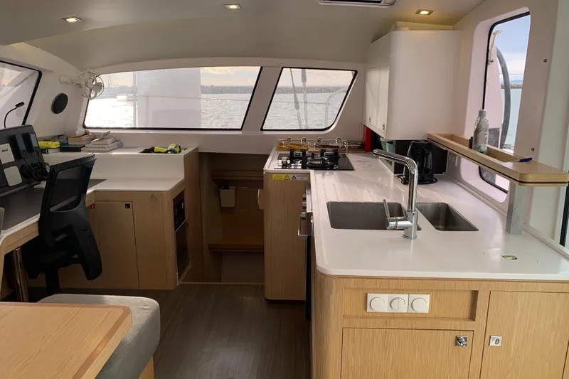 Spekeend Yacht Photos Pics Modern kitchen interior of 2021 Outremer 51 catamaran with sleek design and ocean view.