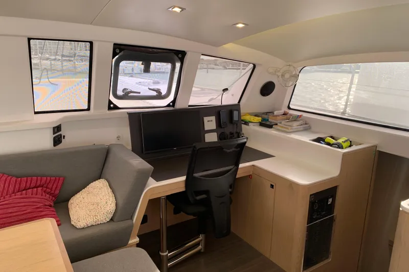 Spekeend Yacht Photos Pics Interior of 2021 Outremer 51 yacht with modern navigation station and cozy seating area.