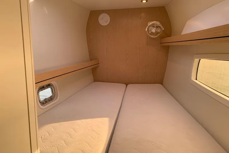 Spekeend Yacht Photos Pics Interior cabin of 2021 Outremer 51 yacht, featuring twin beds and wooden accents.
