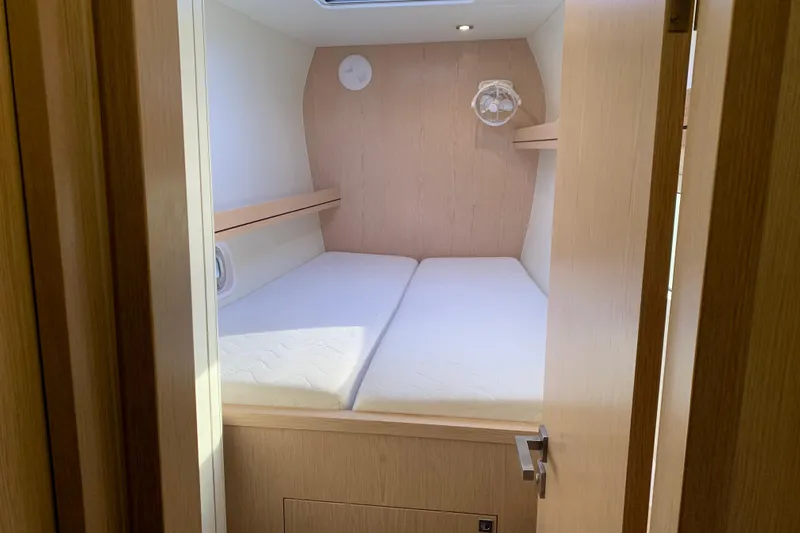 Spekeend Yacht Photos Pics 2021 Outremer 51 yacht cabin interior with cozy bed and wooden finish.