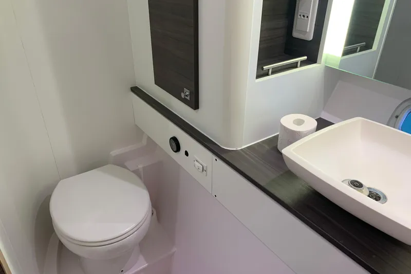 Spekeend Yacht Photos Pics Bathroom interior of 2021 Outremer 51 yacht with modern sink and toilet.
