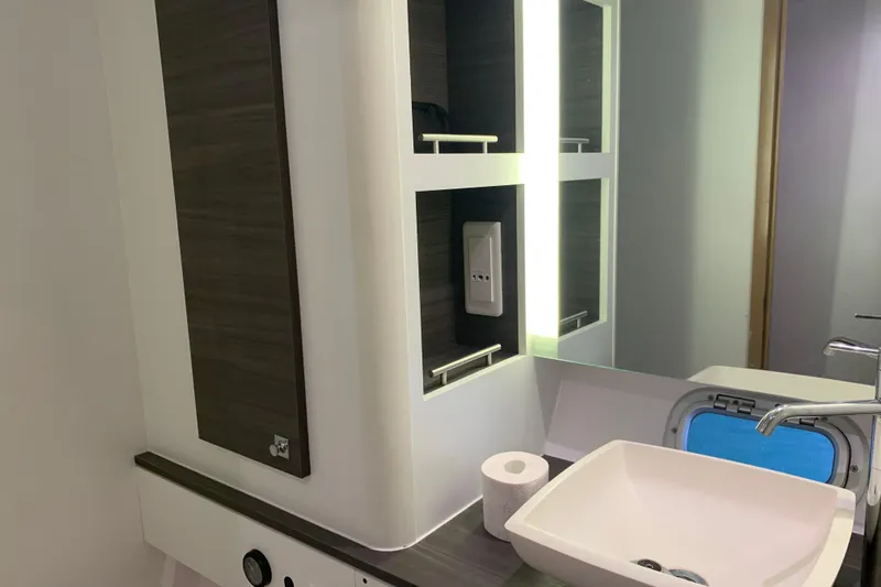 Spekeend Yacht Photos Pics Modern bathroom interior of 2021 Outremer 51 yacht with sink and mirror.