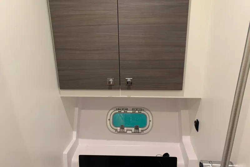 Spekeend Yacht Photos Pics Interior of 2021 Outremer 51 yacht, featuring wooden cabinets and a small window.