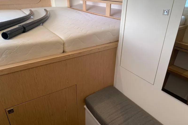 Spekeend Yacht Photos Pics Interior of 2021 Outremer 51 yacht, featuring a cozy cabin with a mattress and storage.