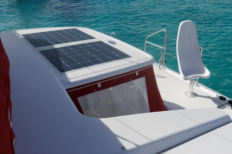 Spekeend Yacht Photos Pics Outremer 51 catamaran 2021 with solar panels and seating, on clear blue water.