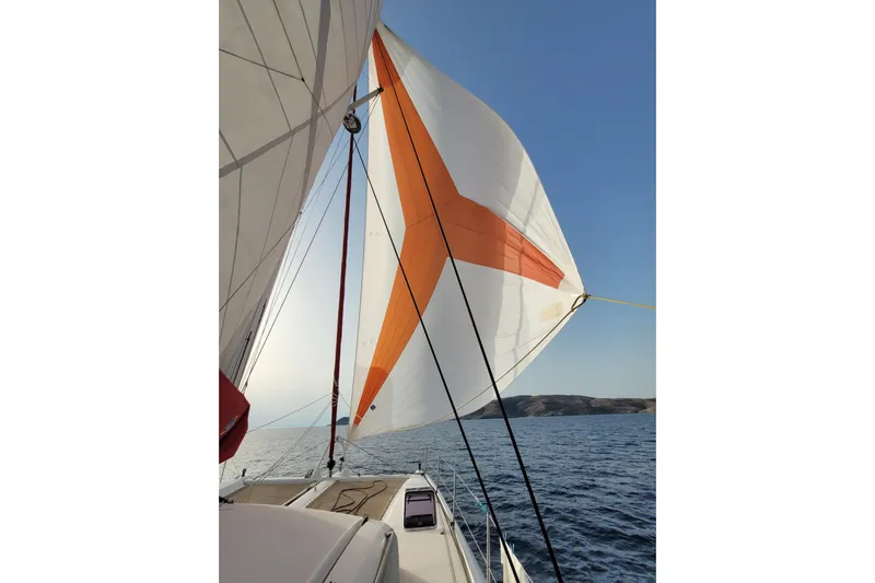 Spekeend Yacht Photos Pics Outremer 51 sailboat with vibrant sails on open sea, 2021 model.