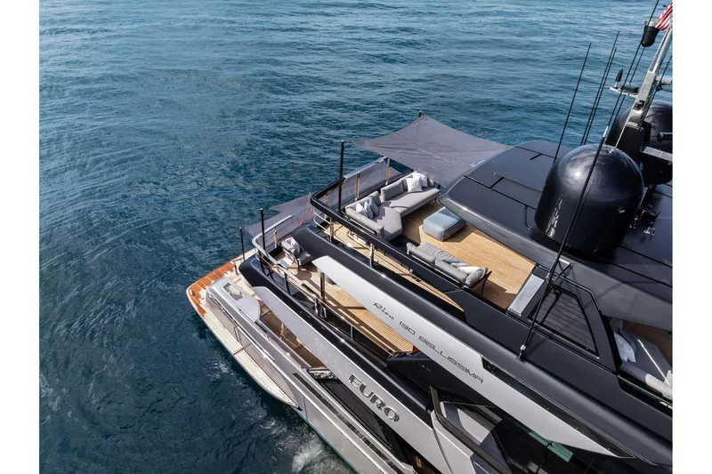 Euro Yacht Photos Pics Luxurious 2024 Riva 130' Bellissima yacht with elegant deck and seating area on the ocean.