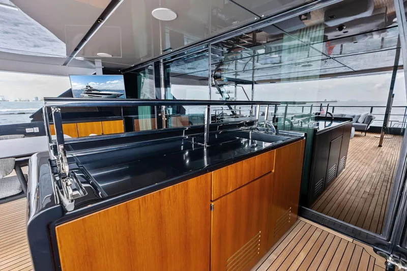 Euro Yacht Photos Pics Luxurious 2024 Riva 130' Bellissima yacht interior with sleek wooden cabinetry and modern design.
