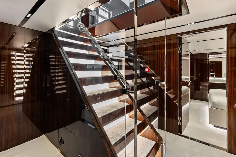 Euro Yacht Photos Pics Luxurious interior of 2024 Riva 130' Bellissima yacht with elegant staircase and modern design.