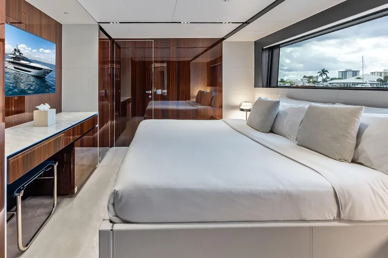 Euro Yacht Photos Pics Luxurious bedroom interior of 2024 Riva 130' Bellissima yacht with elegant wood finishes.