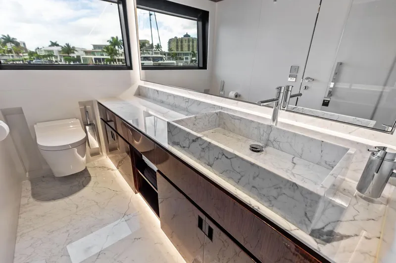 Euro Yacht Photos Pics Luxurious marble bathroom in 2024 Riva 130' Bellissima yacht, featuring modern fixtures and elegant design.