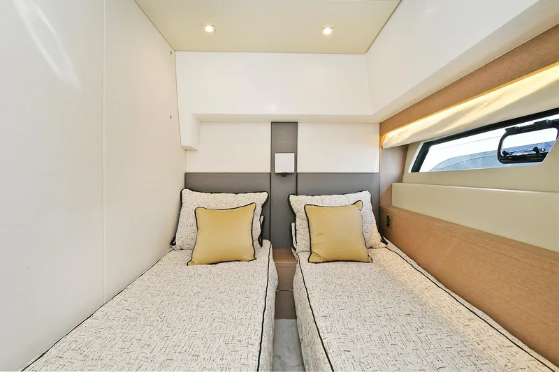  Yacht Photos Pics Twin cabin interior of 2018 Prestige 560 Fly yacht with modern design and cozy bedding.