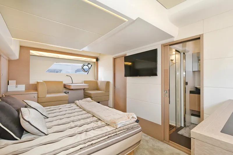  Yacht Photos Pics Luxurious interior of 2018 Prestige 560 Fly yacht with modern bedroom and seating area.