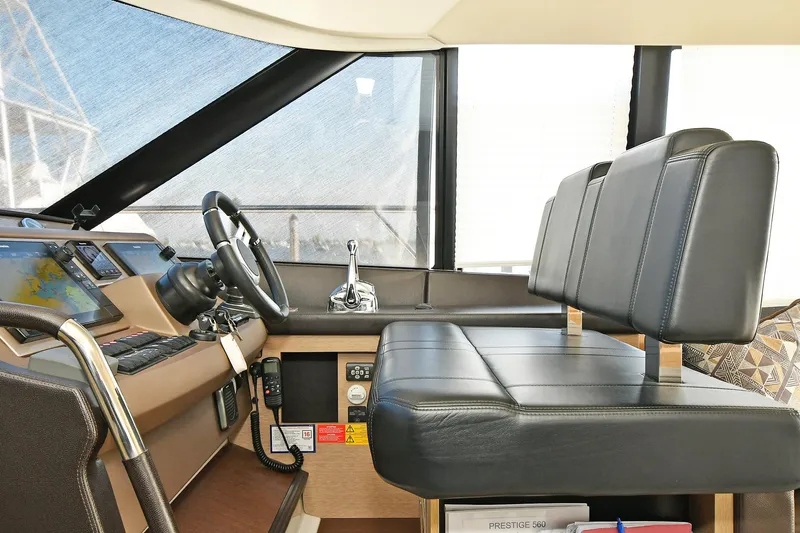  Yacht Photos Pics Interior helm of 2018 Prestige 560 Fly yacht with leather seating and modern controls.