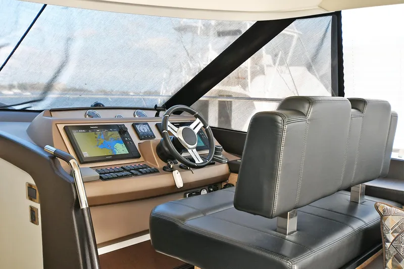  Yacht Photos Pics Interior helm of 2018 Prestige 560 Fly yacht with navigation system and leather seating.