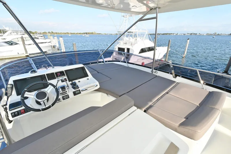  Yacht Photos Pics Flybridge view of 2018 Prestige 560 Fly yacht with helm and seating area.