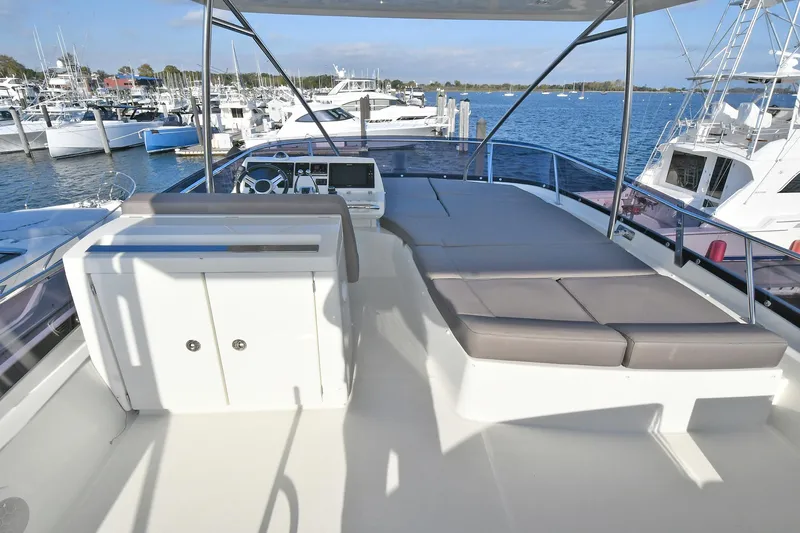  Yacht Photos Pics Flybridge of 2018 Prestige 560 Fly yacht with seating, overlooking marina.