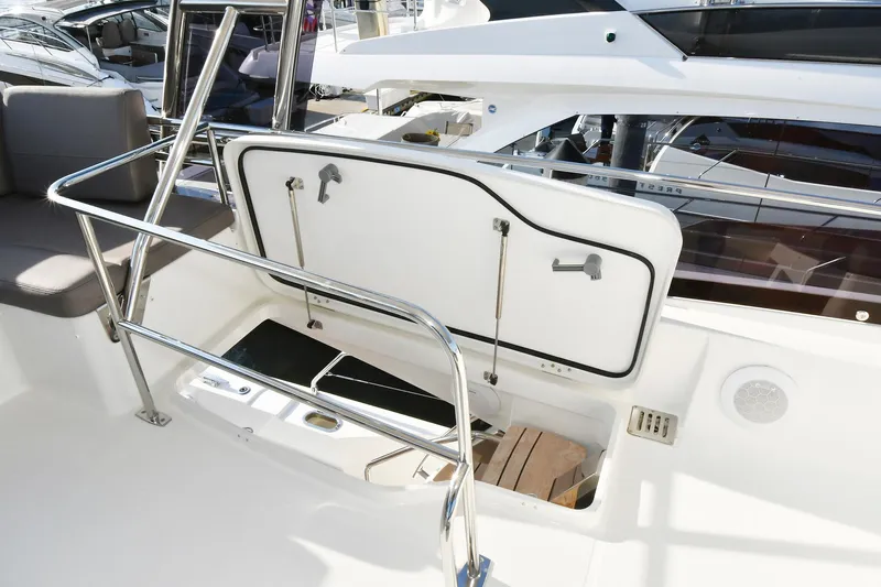  Yacht Photos Pics 2018 Prestige 560 Fly yacht deck with open storage compartment and stainless steel railings.