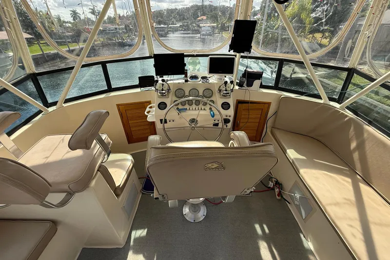 Luv'n Life Yacht Photos Pics 1989 Atlantic 47 Motor Yacht helm with steering wheel, navigation equipment, and seating.