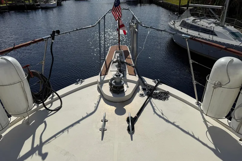 Luv'n Life Yacht Photos Pics 1989 Atlantic 47 Motor Yacht bow with anchor and American flag in marina.
