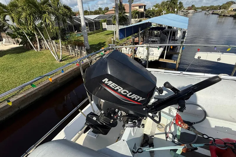 Luv'n Life Yacht Photos Pics 1989 Atlantic 47 Motor Yacht with Mercury outboard motor, docked by a canal.